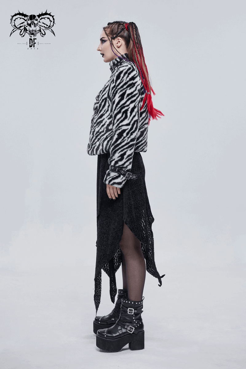 Stylish woman in zebra-stripe jacket with stand collar, paired with black skirt and platform boots, showcasing alternative fashion.