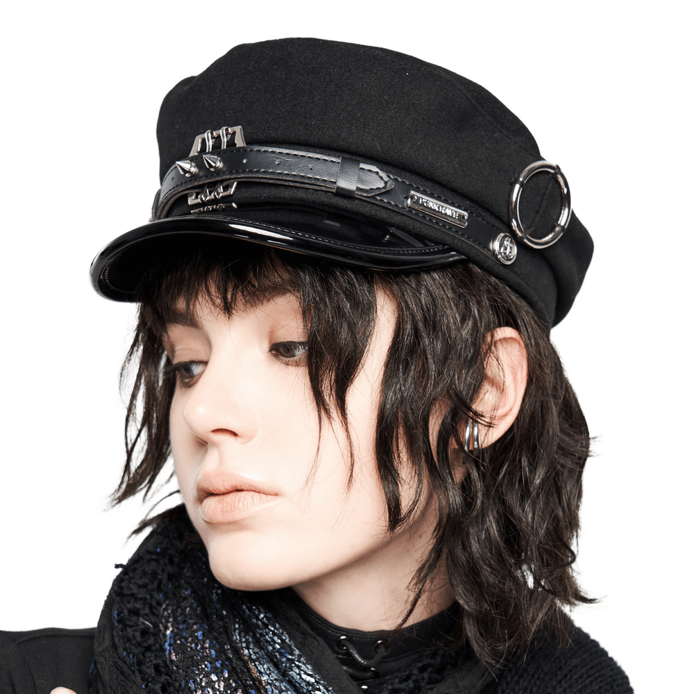 Stylish punk woolen cap with PU brim and metal accents on a model with tousled hair.