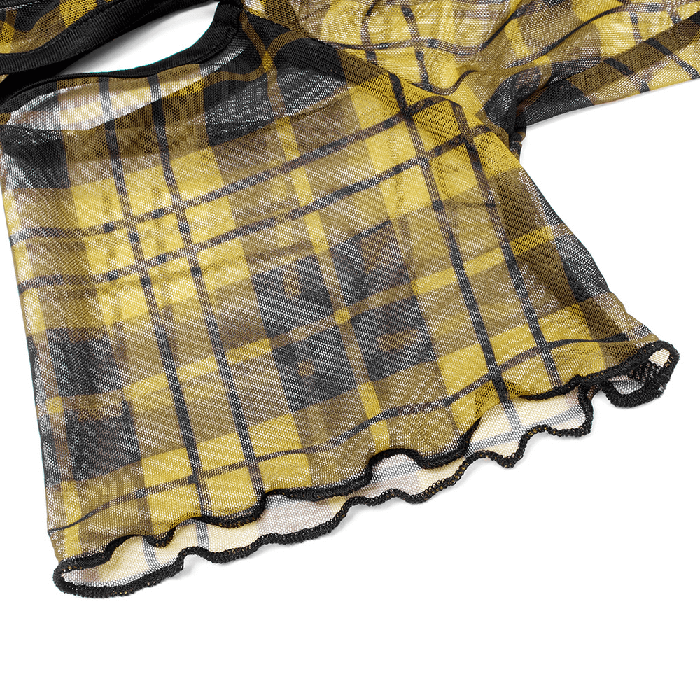 Close-up of yellow plaid mesh fabric with black trim, showcasing the edgy design of a punk T-shirt.