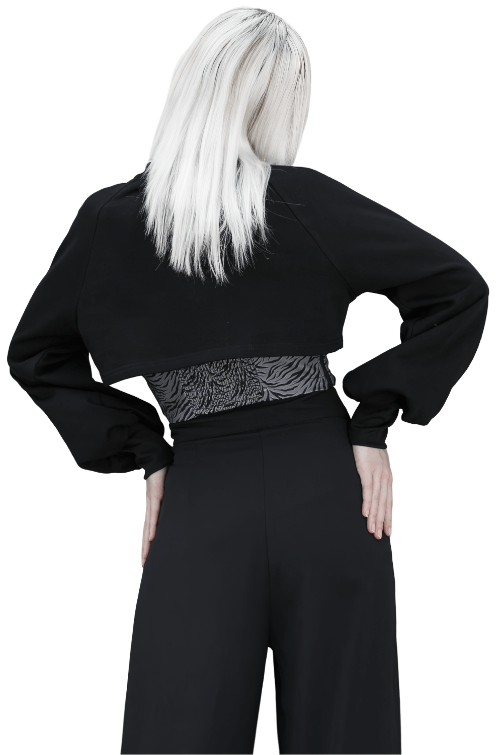 Back view of a model wearing a black zip-up crop jacket with long sleeves and stylish chain detail.
