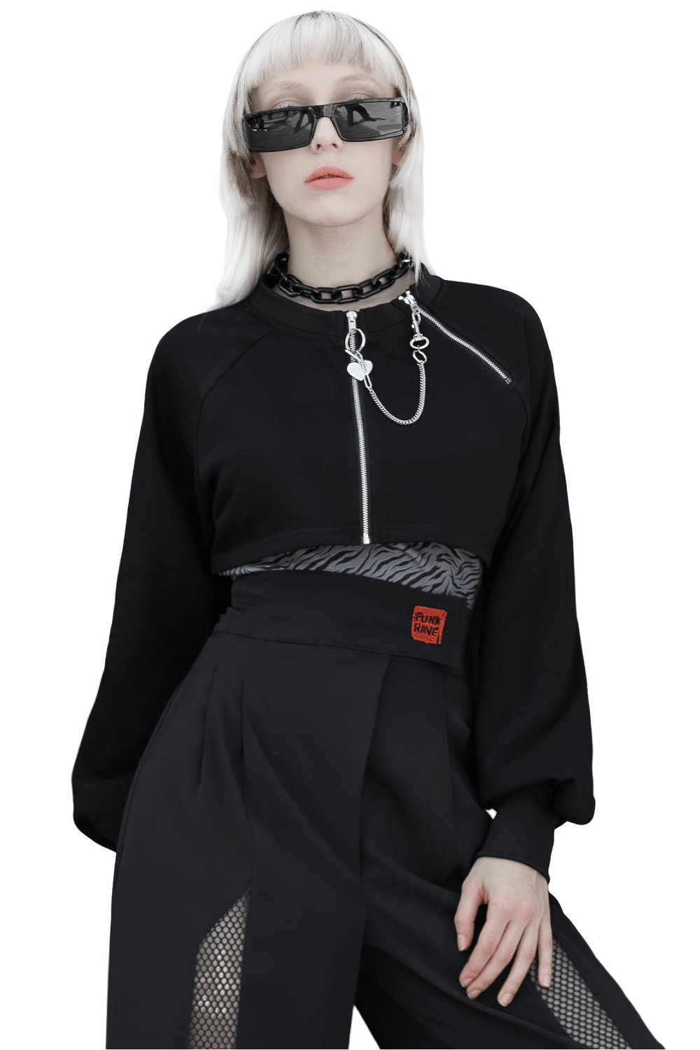 Edgy black zip-up crop jacket with chain detail, paired with stylish oversized sunglasses and black pants.