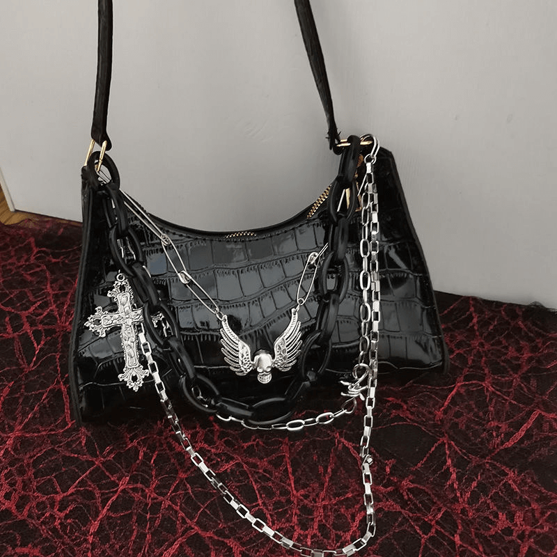 Stylish zipper crocodile pattern handbag with detachable chains and cross skull emblem for a punk-chic aesthetic.