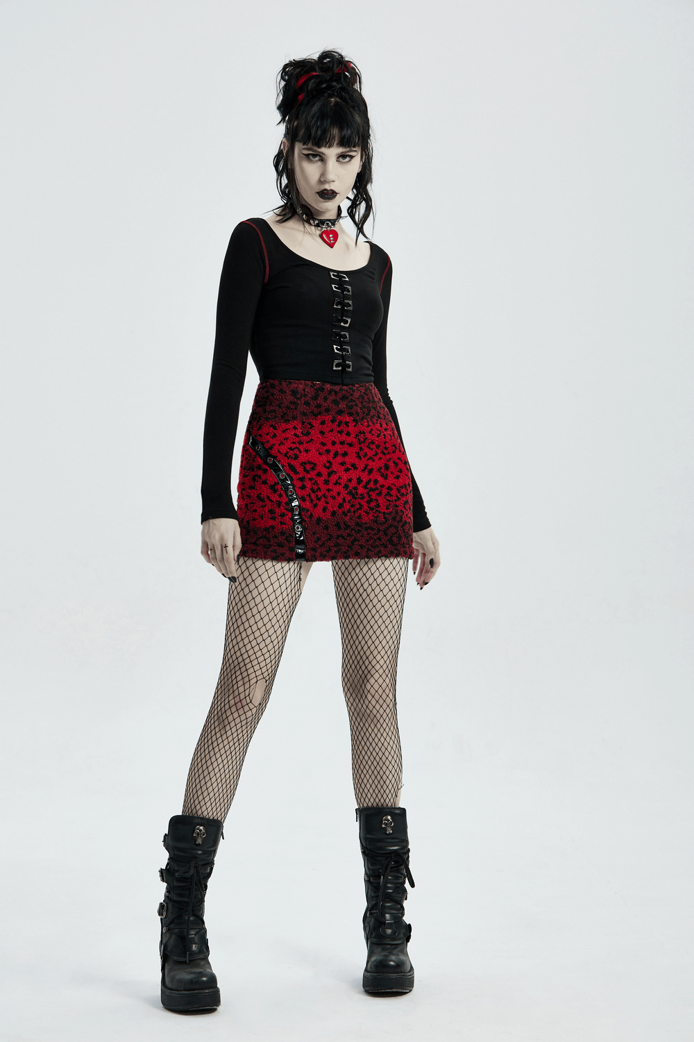 Punk-inspired model in a red leopard mini skirt and black top, showcasing edgy style with fishnet tights and chunky boots.