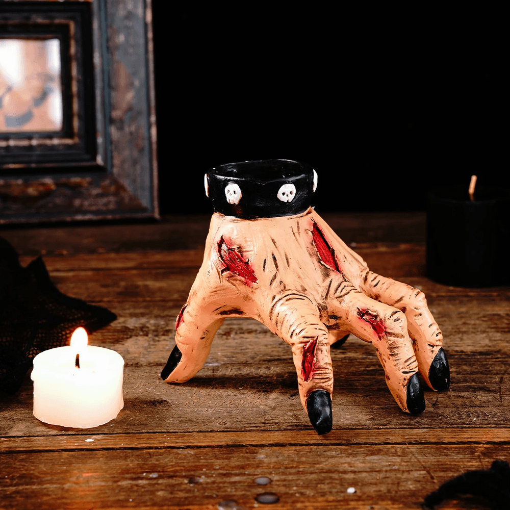 Zombie Hand Candle Holder with Gothic Skull Cuff showcasing a horror-themed decor piece with a bloodied hand and candle.