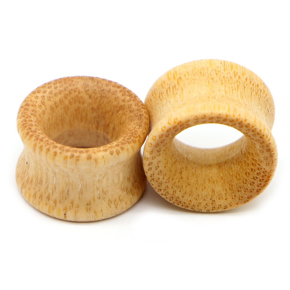 Two bamboo wood ear plugs with hollow design, perfect for trendy jewelry gauges and flesh tunnel expansion.
