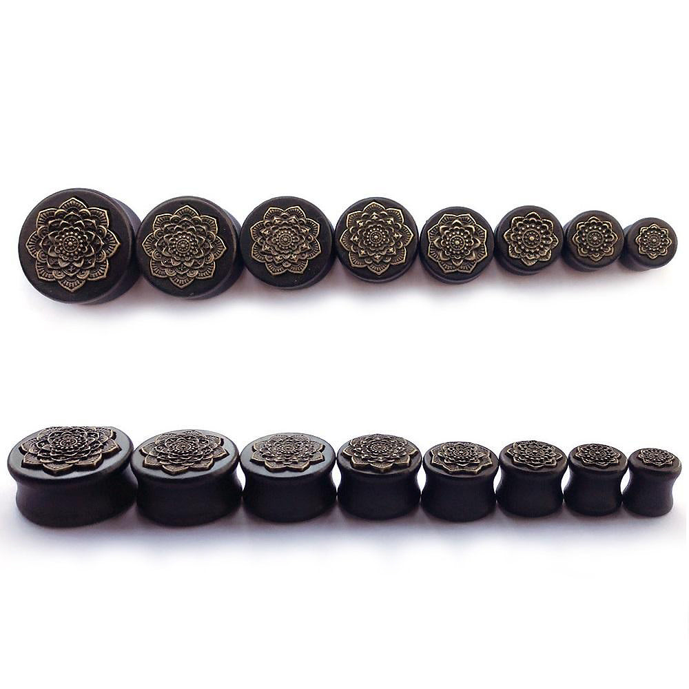 Collection of bamboo wood ear plugs with carved mandala design, perfect for stretching earlobes in stylish rock fashion.