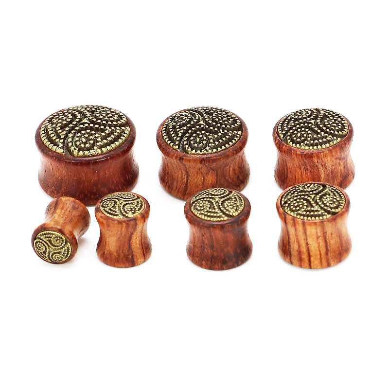 Set of bamboo wood ear plugs and gauges with decorative patterns, perfect for comfortable stretching.