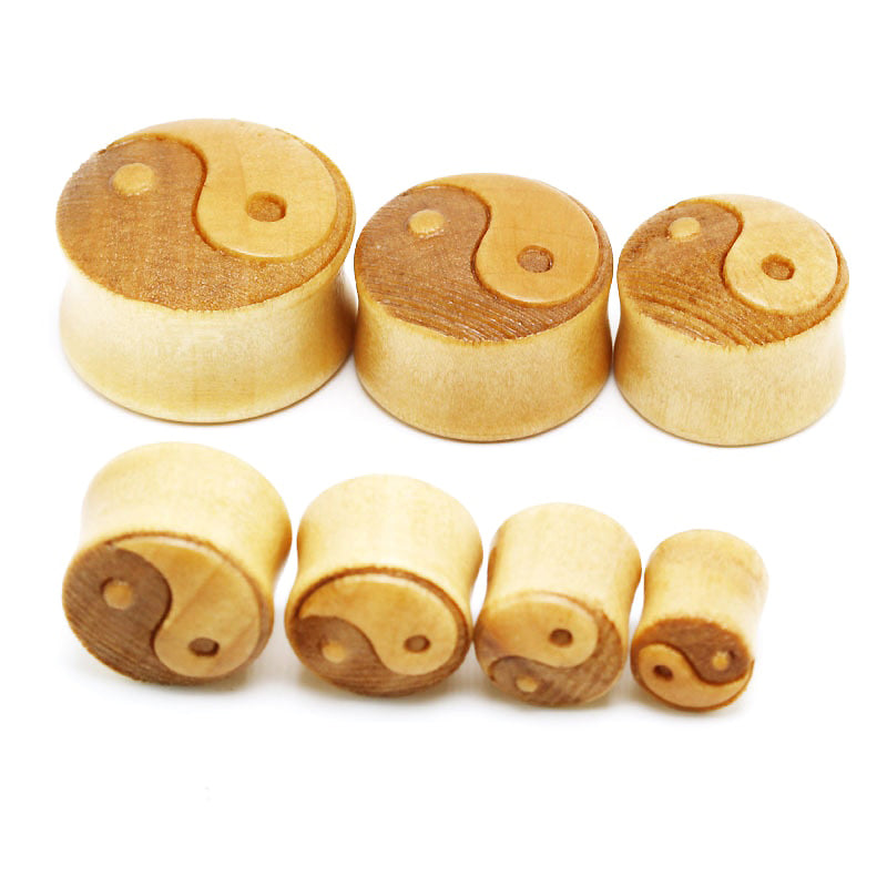 Set of bamboo wood ear plugs featuring yin-yang symbols, stylish and comfortable jewelry gauges for unisex.