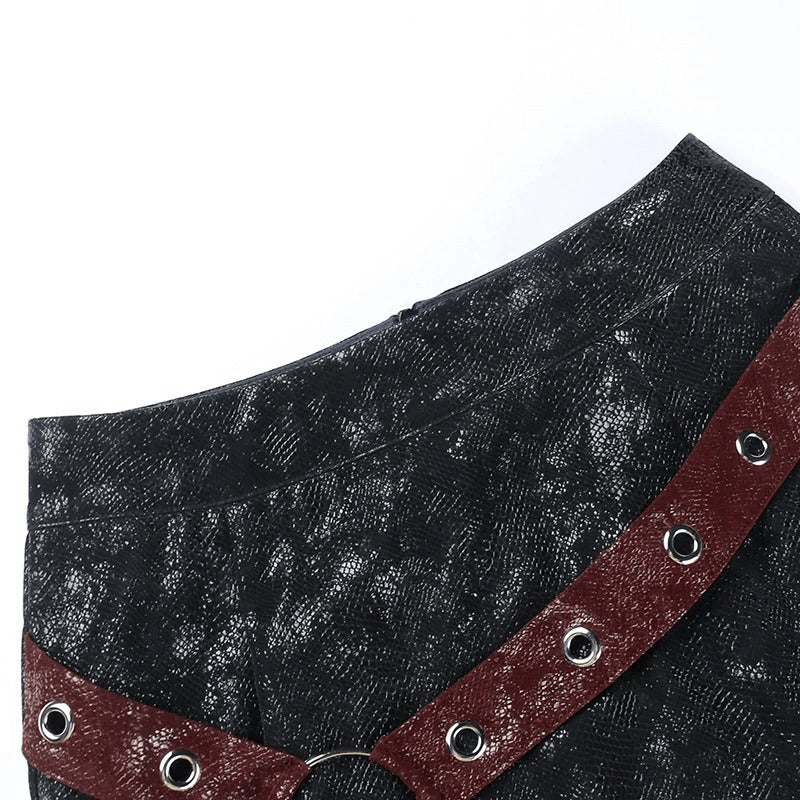 Close-up of a women's high-waisted mini skirt with rivet straps and rings, showcasing a stylish punk design.