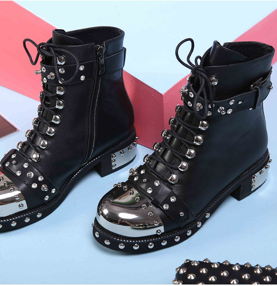 Genuine leather punk rock boots for women with rivets, chains, and square heels, perfect for a bold, stylish look.