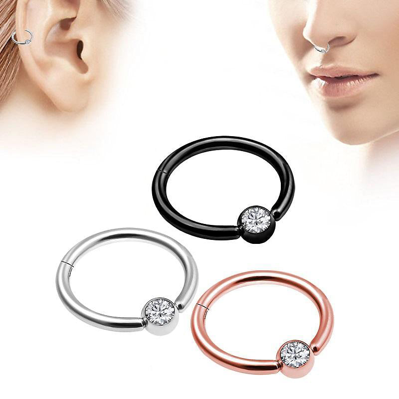 Stylish double-layered steel clicker nose hoops in black, silver, and rose gold with a crystal decoration.