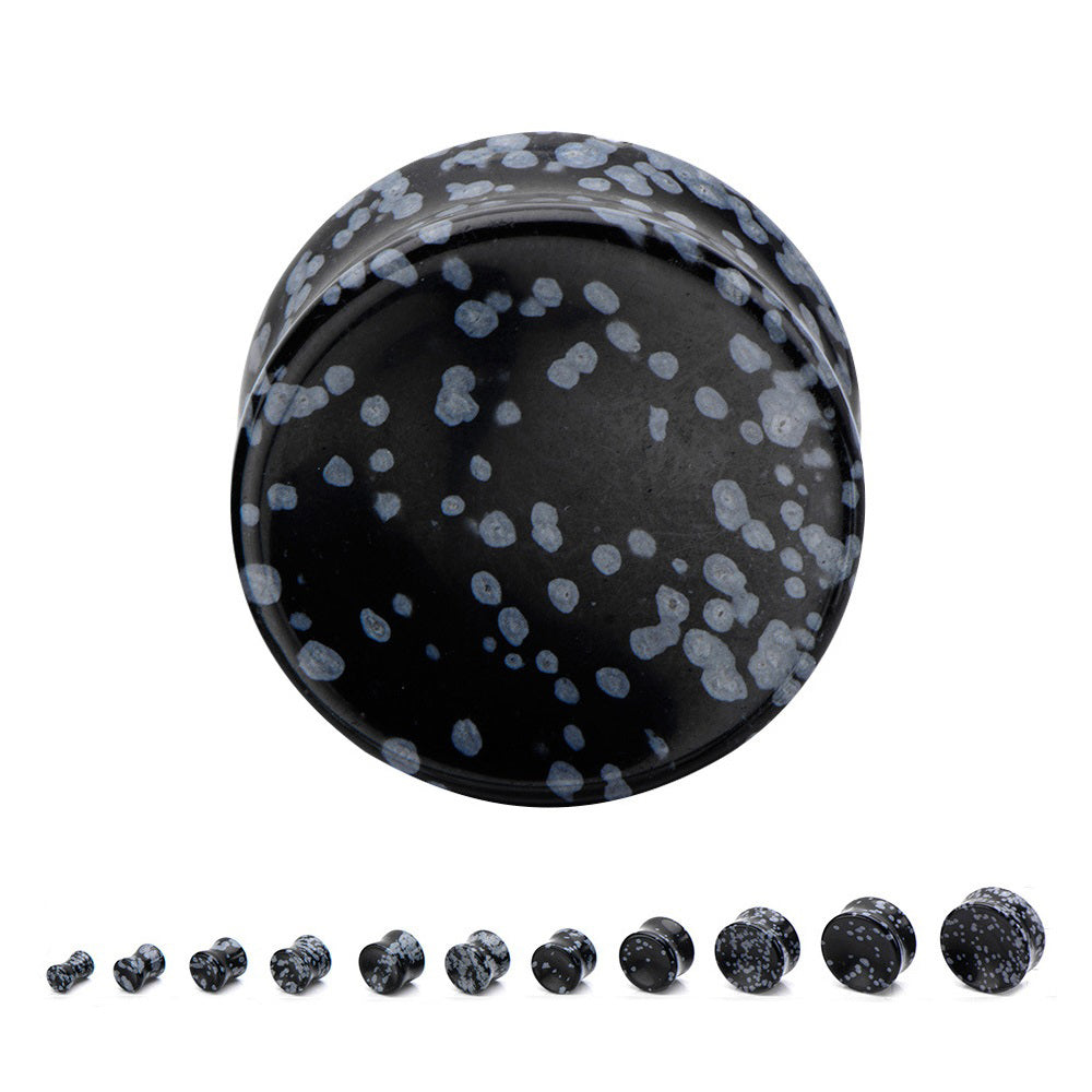 Black alabaster stone ear plugs with speckled design, perfect for stylish body jewelry enthusiasts.