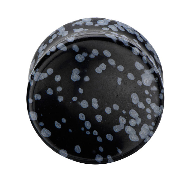Black stone ear plug with blue speckles, perfect for stylish body jewelry enthusiasts. Unisex alternative accessory.