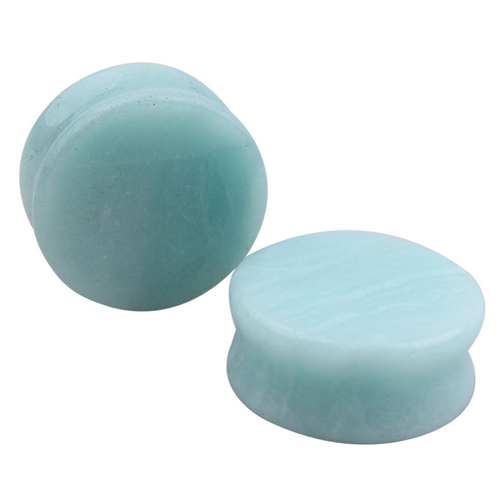 Stone ear plugs made of amazonite, showcasing a shiny, smooth surface for stylish body jewelry.