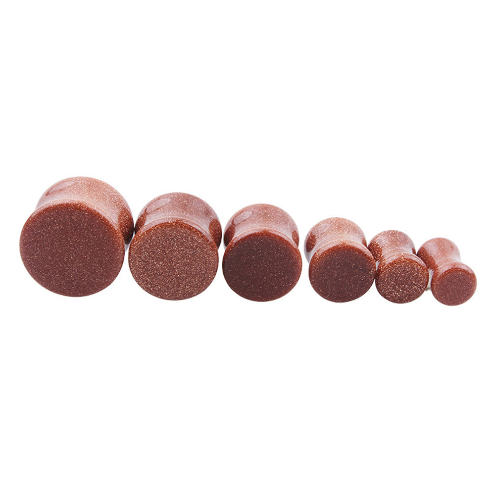 Set of six stone ear plugs in golden sand color, perfect for body jewelry and gauging with trendy designs.