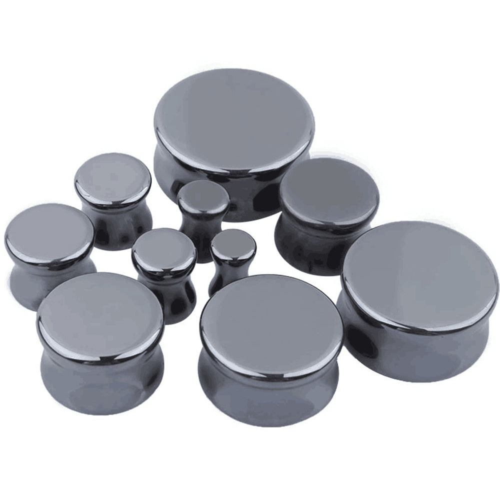 Set of hematite stone ear plugs and gauges in various sizes for body jewelry and piercings.