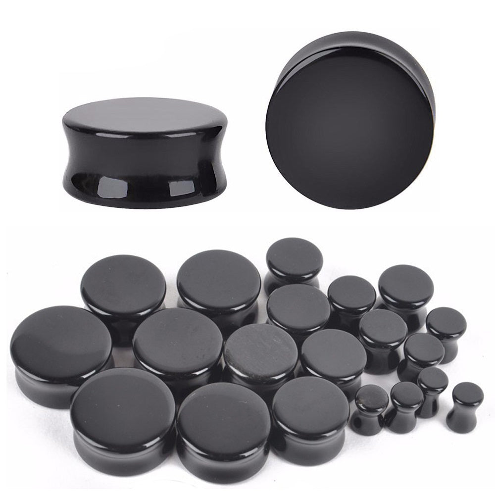 Black obsidian stone ear plugs and gauges in various sizes, perfect for trendy body jewelry enthusiasts.