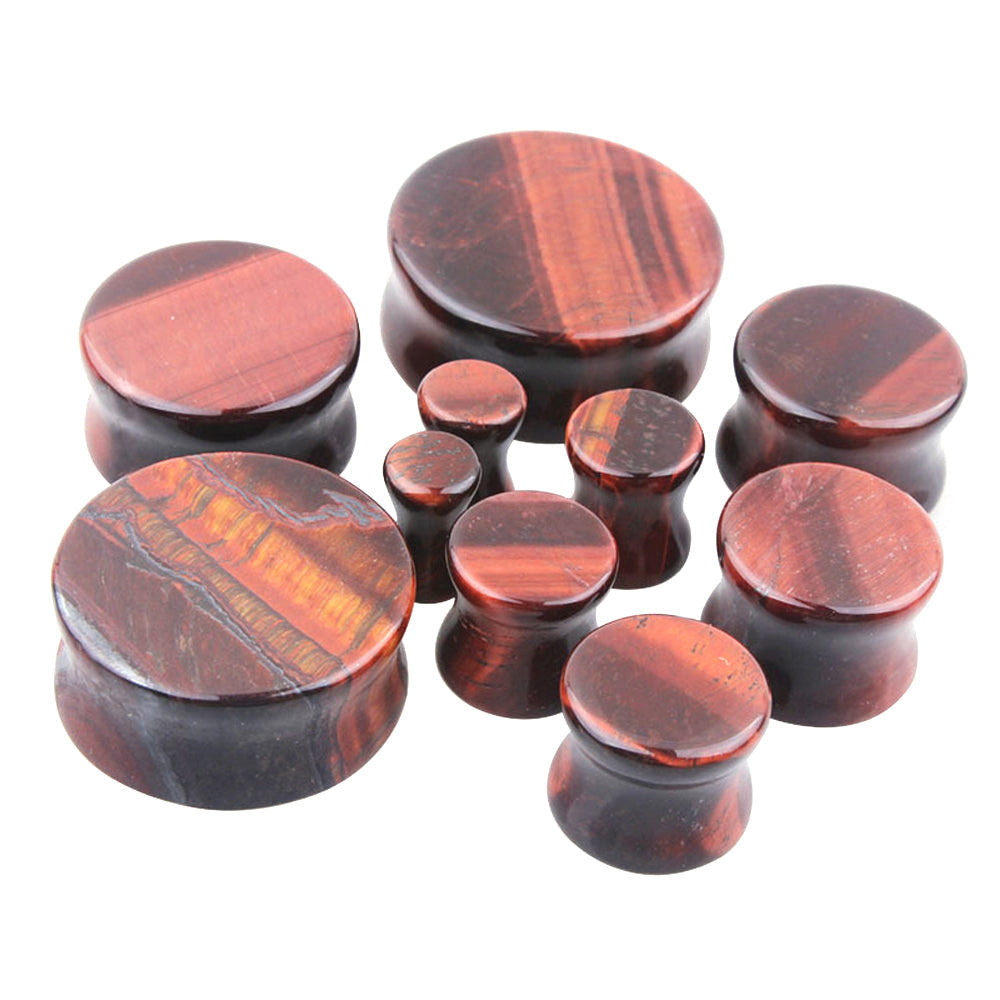 Red tigerite stone ear plugs and gauges in various sizes, perfect for a stylish body jewelry collection.