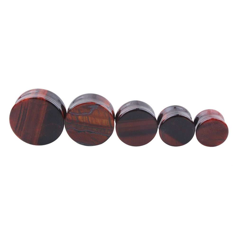 Set of five red tigerite stone ear plugs and gauges, designed for stylish alternative body jewelry.