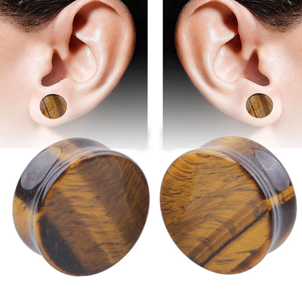 Yellow Tigerite stone ear plugs showcased on a model's ears, perfect for rock style body jewelry.