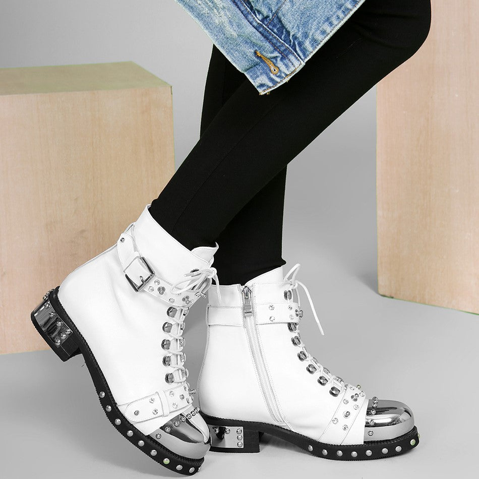 Stylish women's genuine leather punk rock boots with rivets, chains, and shiny square heels, perfect for a biker look.