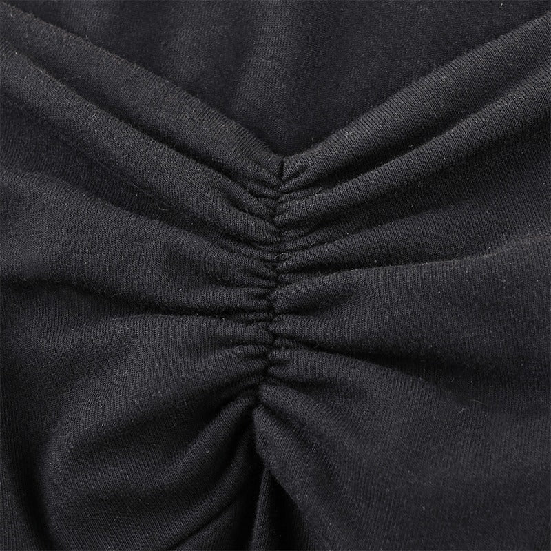 Close-up of gathered fabric detail on a stylish black gothic dress, showcasing elegant texture and quality material.