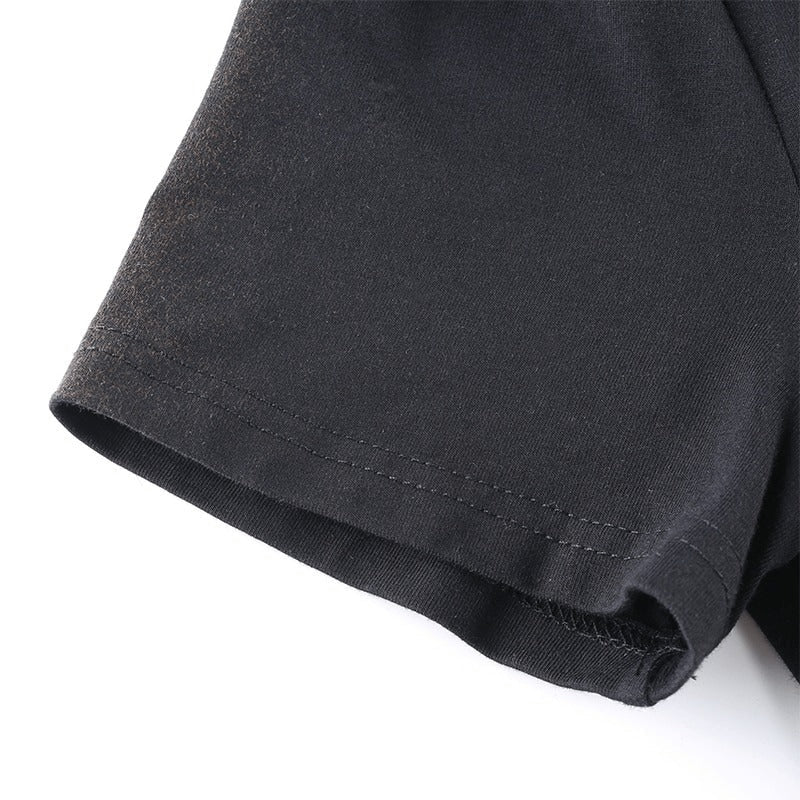 Close-up of the hem of a stylish black dress showcasing short sleeves and quality fabric craftsmanship.