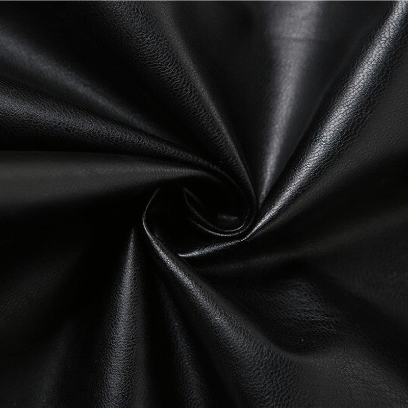 Close-up of black faux leather fabric, showcasing its smooth texture for punk rock clothing.
