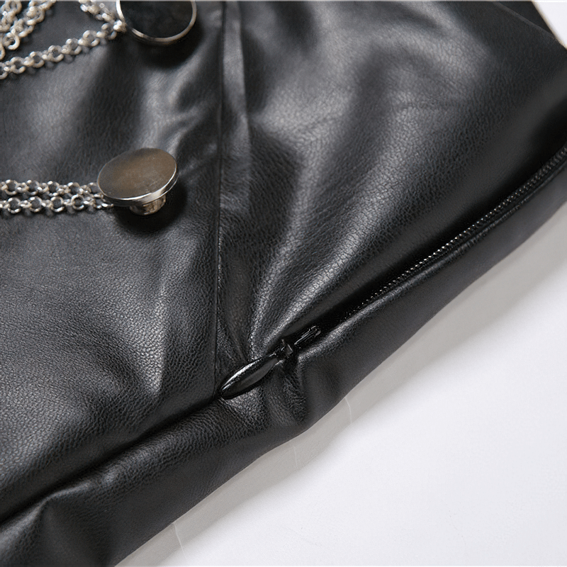 Close-up of black faux leather mini skirt featuring a zipper and silver chain details.