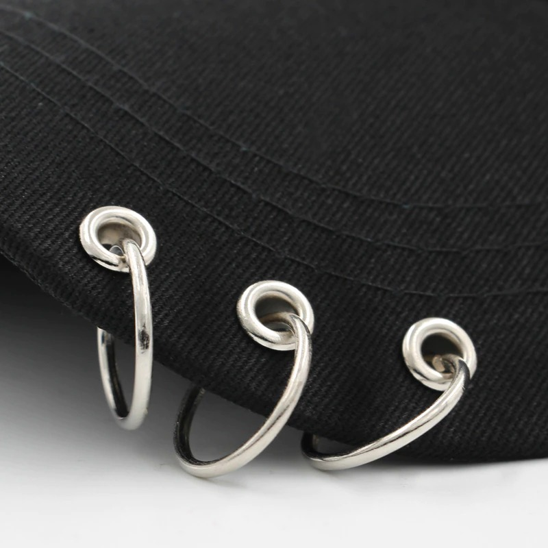 Close-up of adjustable unisex baseball cap with silver ring piercings, enhancing punk style and comfort.