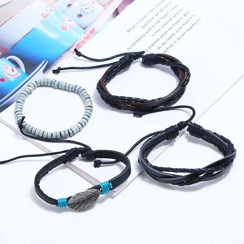 Adjustable leather bracelet set featuring multi-layered punk style bangles for men and women on a stylish surface.