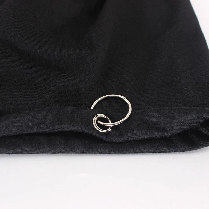 Close-up of a black minimalistic beanie featuring a stylish metal hoop, perfect for a chic autumn and winter look.