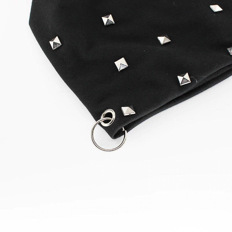 Close-up of trendy black beanie featuring silver studs and a metal ring, perfect for alternative winter fashion.