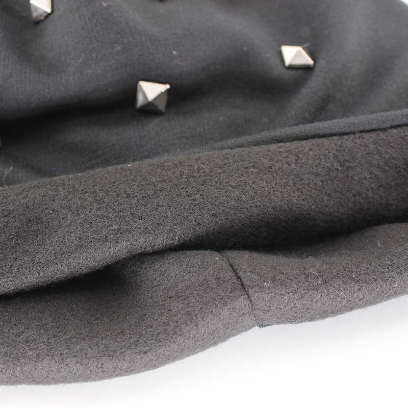 Close-up of black beanie featuring square metal rivets, perfect for alternative autumn and winter fashion.