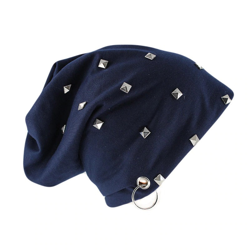 Navy blue beanie with silver studs and metal ring, perfect for alternative winter fashion.