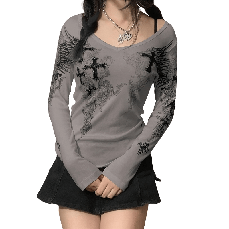 Aesthetic women's long sleeve top featuring cross wings print, stylishly paired with a skirt for a trendy look.