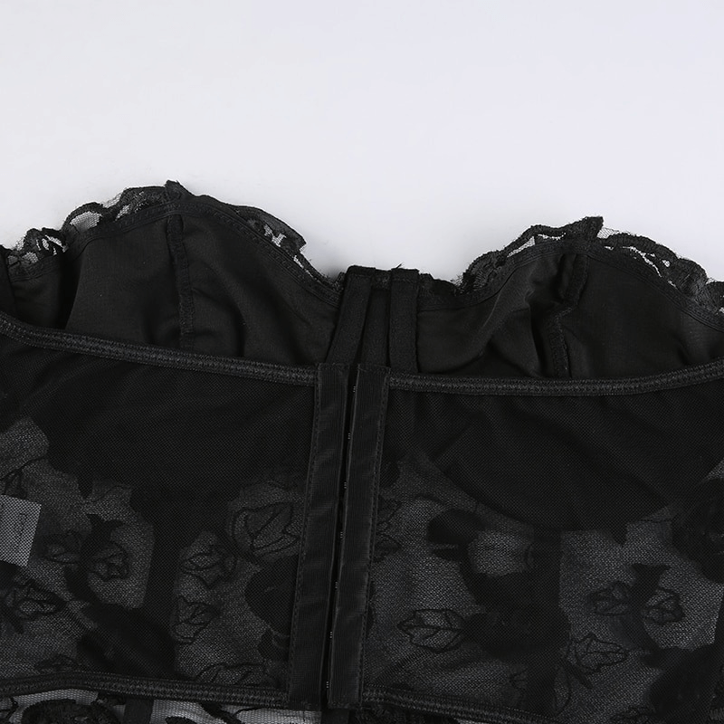 Close-up of a black women's floral lace crop top showcasing its transparent fabric and elegant design.