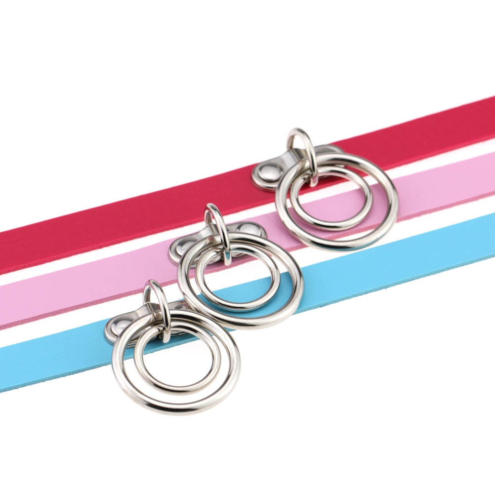 Close-up of multicolor PU leather choker with metal rings in pink, red, and blue. Perfect for gothic and cosplay styles.