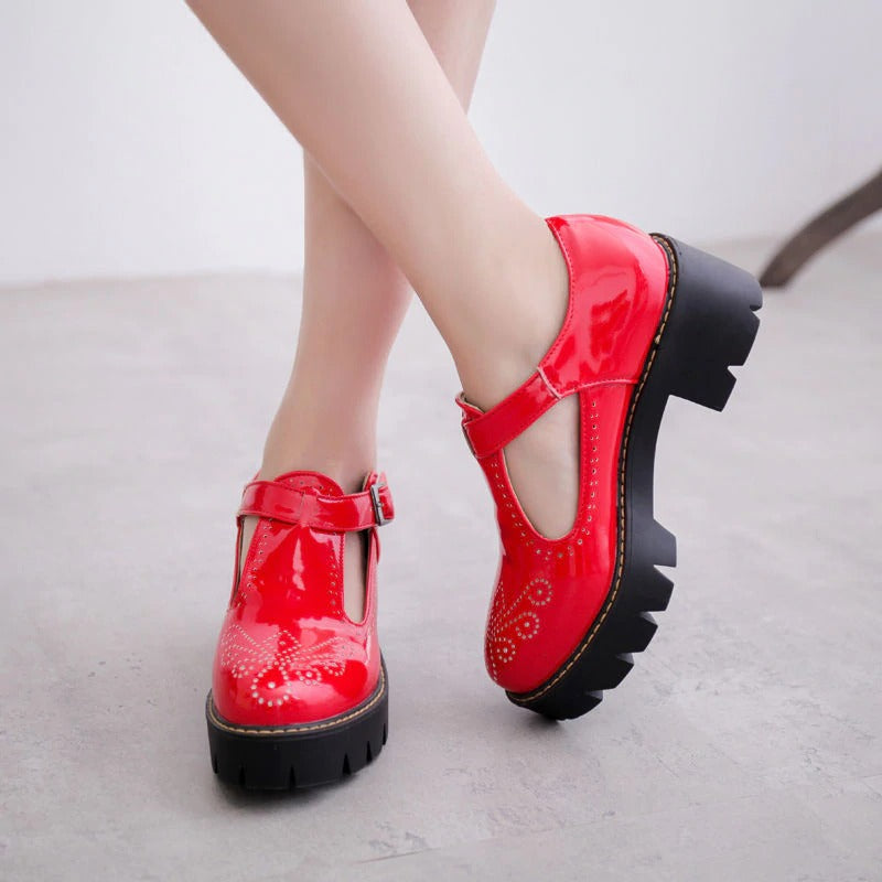 Stylish red brogue round toe flats with buckle strap, perfect for adding a rock-chic vibe to women's fashion.