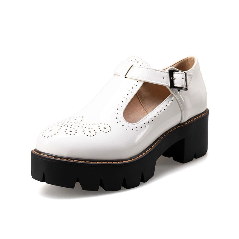 Stylish white brogue round toe flats with buckle strap, perfect for alternative fashion and casual looks.