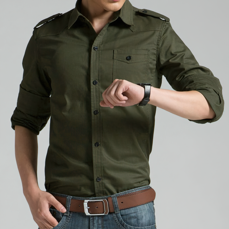 Stylish male in military shirt checks time, showcasing long sleeves and safari style for casual wear.