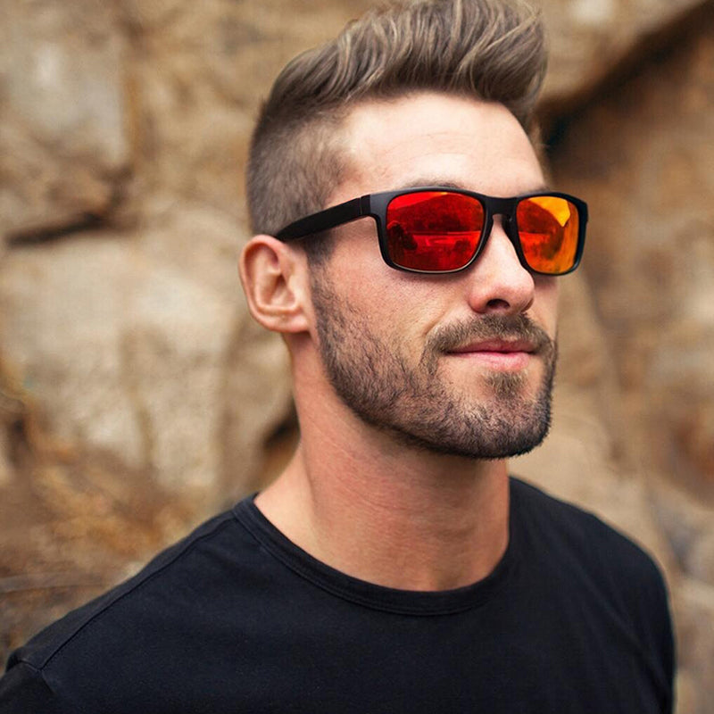Man wearing alternative fashion square polarized sunglasses with orange lenses in a casual outdoor setting.
