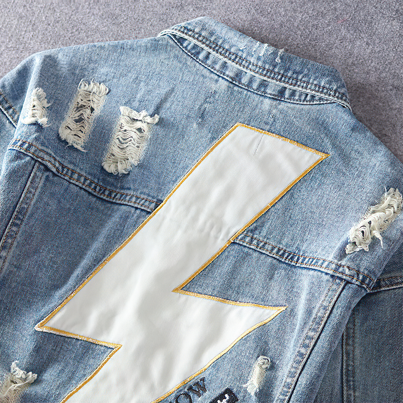 Alternative men's denim jacket with a large white lightning print on the back and distressed detailing.