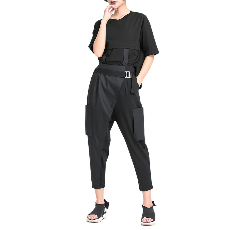 Chic woman in alternative style black trousers and matching top, showcasing a trendy loose fit and stylish pockets.