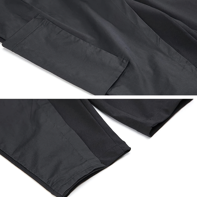 Close-up of alternative style high elastic black trousers showing pockets and fabric details for women's fashion.