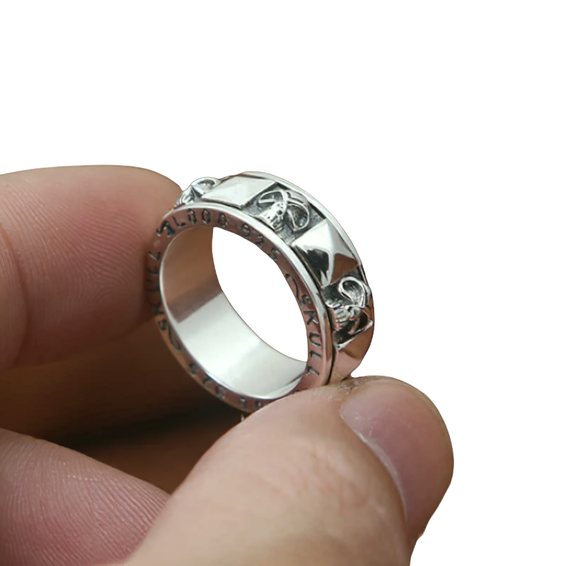 Close-up of a hand holding a stylish unisex 925 sterling silver gothic skull rotate ring.
