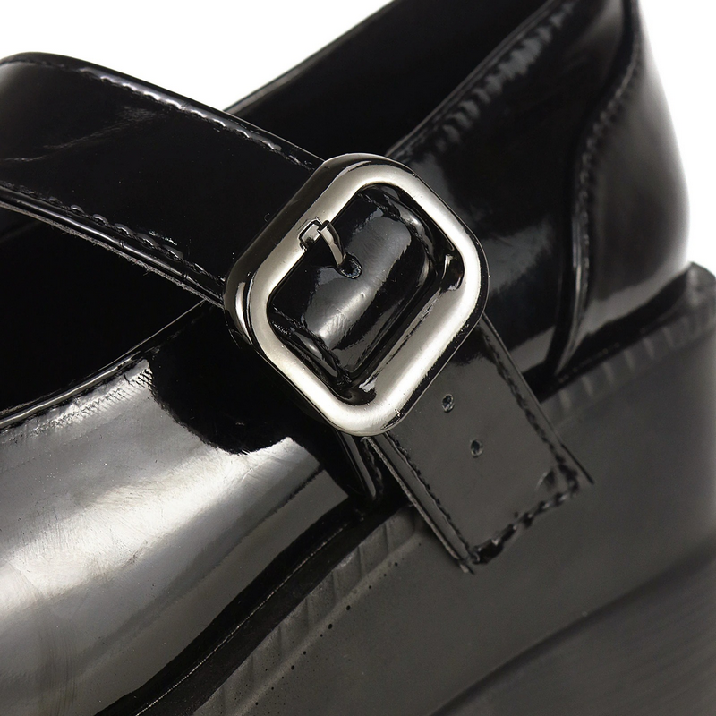 Close-up of black leather high pumps with sleek buckle detail, perfect for gothic outfits and versatile styling.