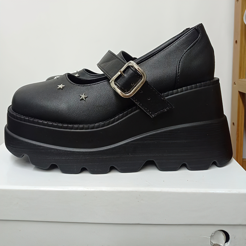 Black platform leather pumps with buckle and star accents, perfect for alternative women's rock-style outfits.