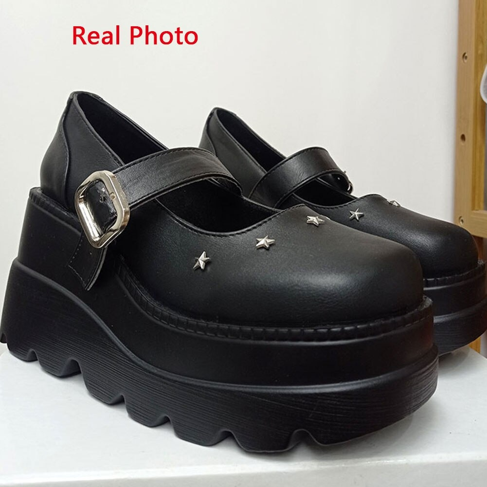 Women's black high pumps with star embellishments and a rubber platform for a stylish rock-inspired look.