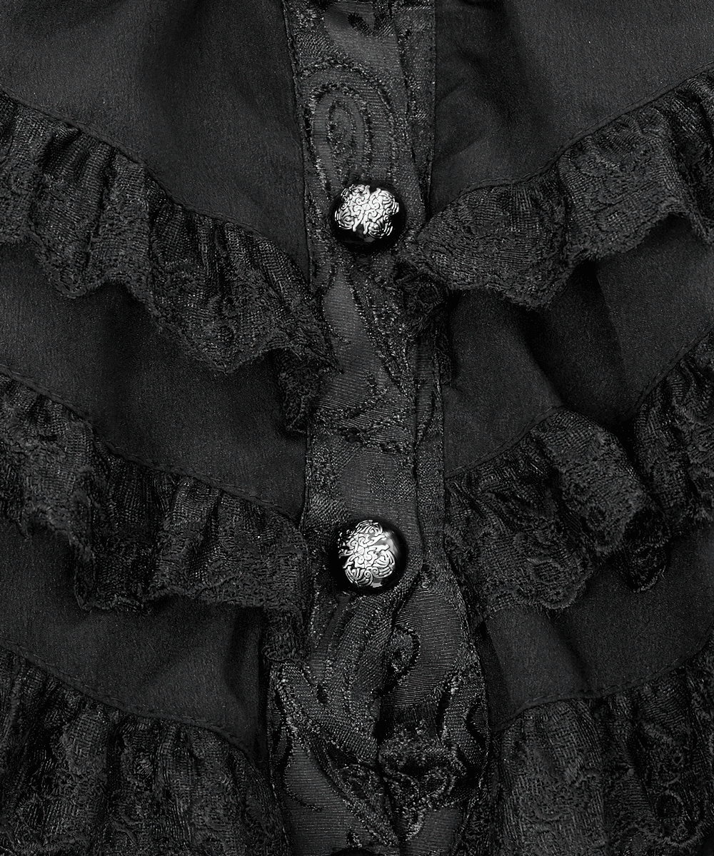 Close-up of delicate black ruffles and ornate buttons on an elegant gothic women's jacket.